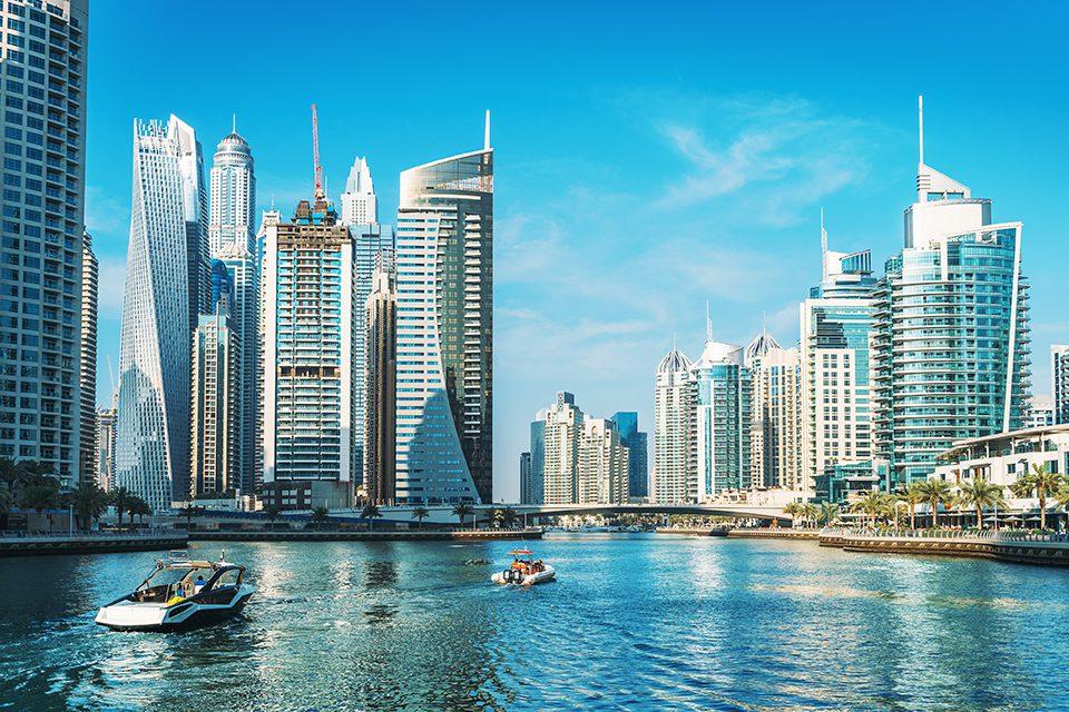 Panorama of Dubai Marina in UAE, modern skyscrapers and port with luxury yachts Source: techbullion.com