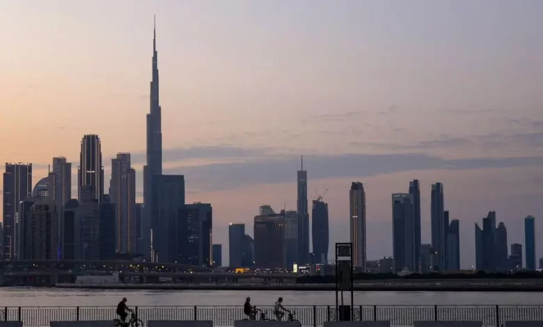 A picture shows people cycling with a general view of the Dubai skyline including Burj Khalifa, the world�s tallest building on November 24, 2023. (Photo by Karim SAHIB / AFP) Agence France-Presse (AFP)/AFP Source: Zawya.com