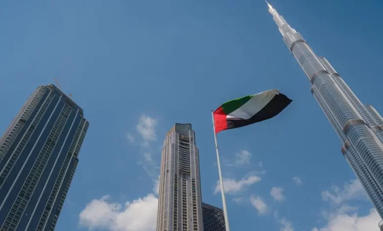 United Arab Emirates flag flying against Dubai downtown skyline. Getty Images Image used for illustrative purpose. Source: Zawya.com