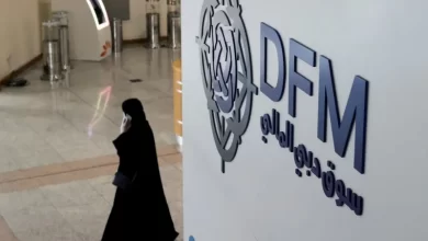 FILE PHOTO: A woman walks through the Dubai Financial Market in Dubai