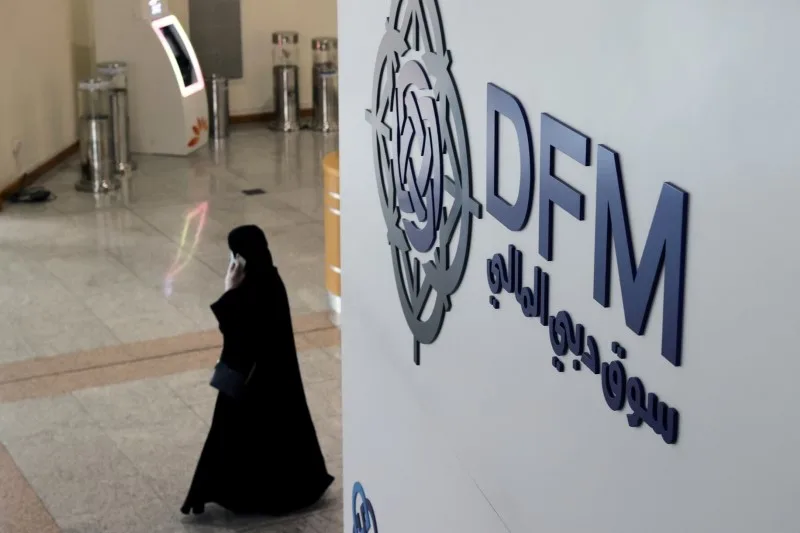 FILE PHOTO: A woman walks through the Dubai Financial Market in Dubai